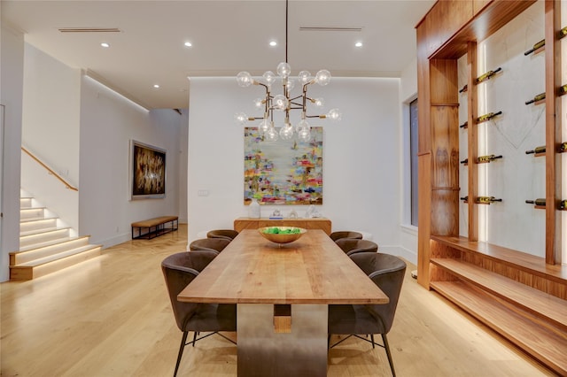 1810 Dunlavy St, Houston, TX 77006 - dining room with light wood finished floors, stairway, a chandelier, and recessed lighting