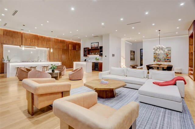 1810 Dunlavy St, Houston, TX 77006 - living area featuring wine cooler, a chandelier, light wood-style floors, and recessed lighting