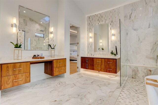 1810 Dunlavy St, Houston, TX 77006 - ensuite bathroom with a marble finish shower, two vanities, and a soaking tub