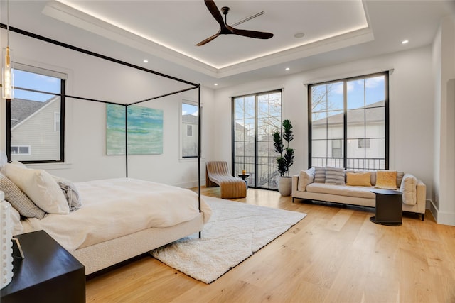 1810 Dunlavy St, Houston, TX 77006 - bedroom featuring a tray ceiling, multiple windows, light wood-type flooring, baseboards, and recessed lighting