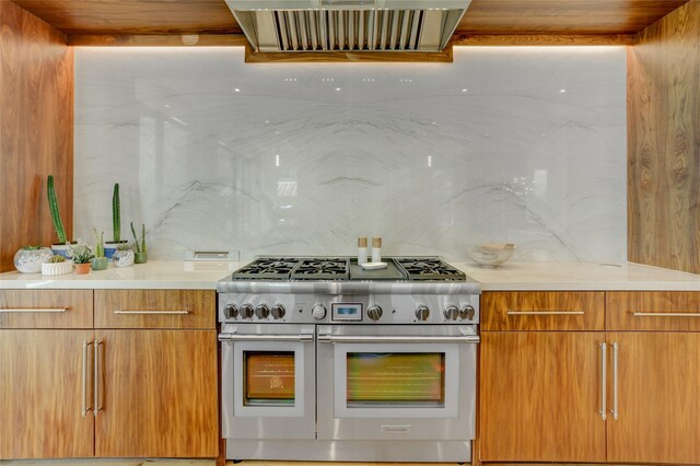 1810 Dunlavy St, Houston, TX 77006 - kitchen featuring double oven range, extractor fan, modern cabinets, and light countertops