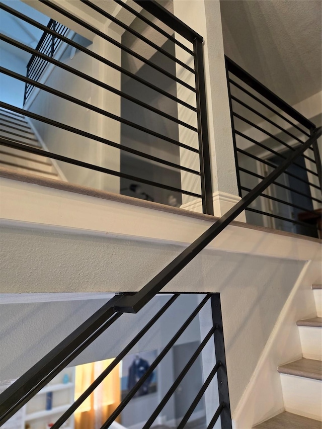 stairs with radiator and a textured wall