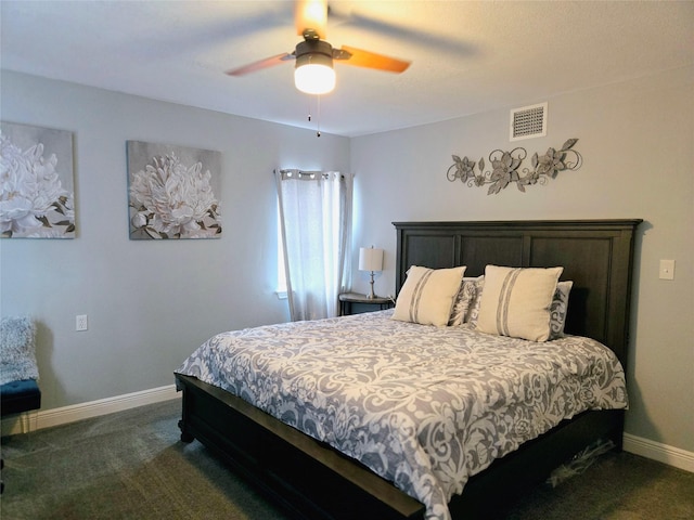 bedroom featuring dark colored carpet, baseboards, and a ceiling fan