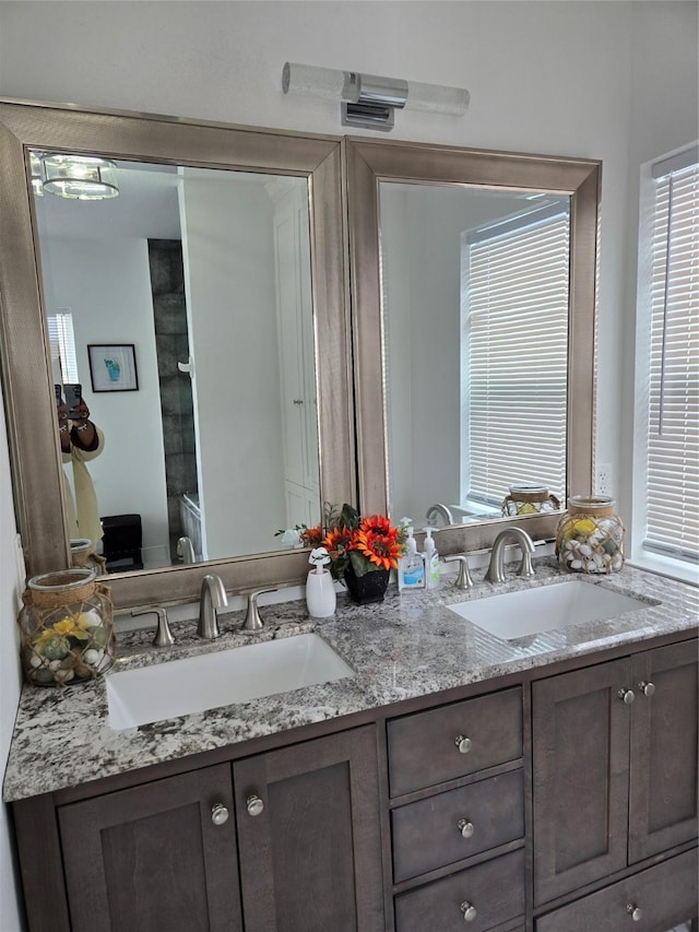 full bath with toilet and double vanity