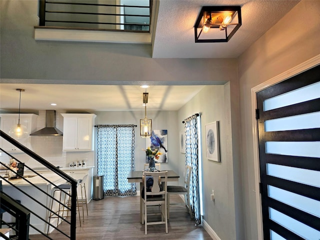 foyer entrance featuring wood finished floors, stairs, and baseboards