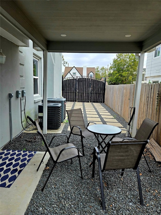 view of patio / terrace with fence and cooling unit