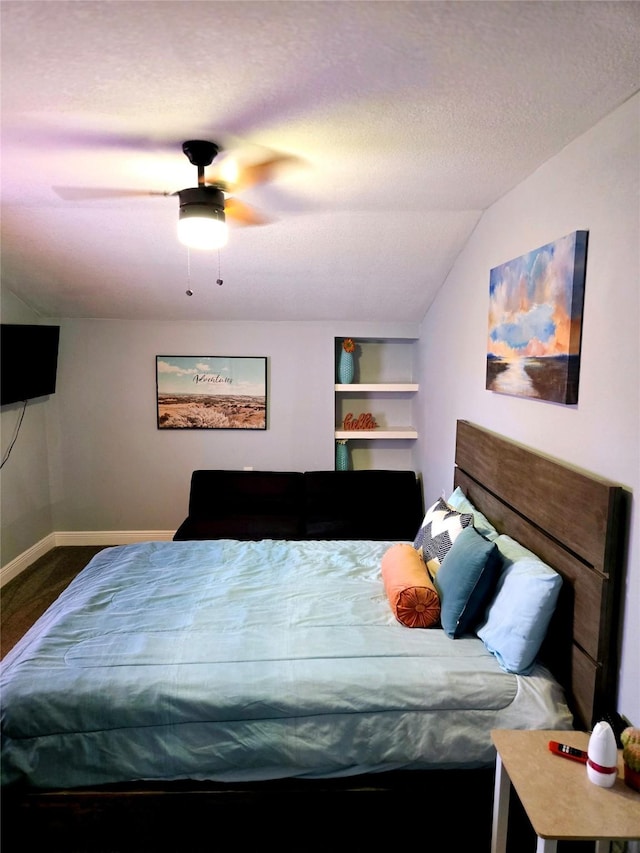 bedroom featuring vaulted ceiling, a ceiling fan, and baseboards