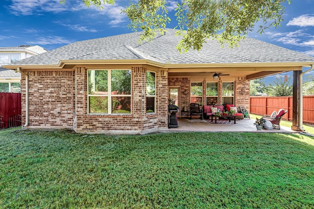 rear view of property featuring an outdoor living space, ceiling fan, brick siding, a shingled roof, and a patio area