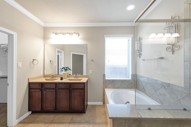 full bath featuring ornamental molding, tiled bath, double vanity, tile patterned floors, and baseboards