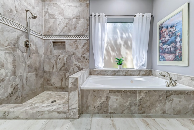 bathroom with a bath, a tile shower, and a healthy amount of sunlight