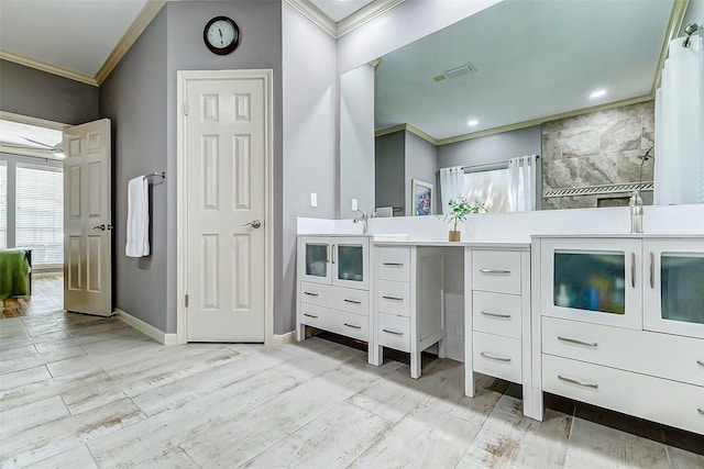 full bath with baseboards, a shower with shower curtain, ornamental molding, vanity, and wood finished floors