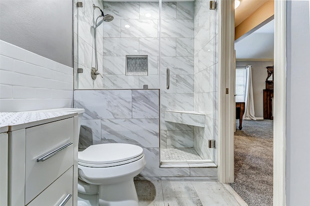 full bath featuring toilet, tile walls, and a stall shower