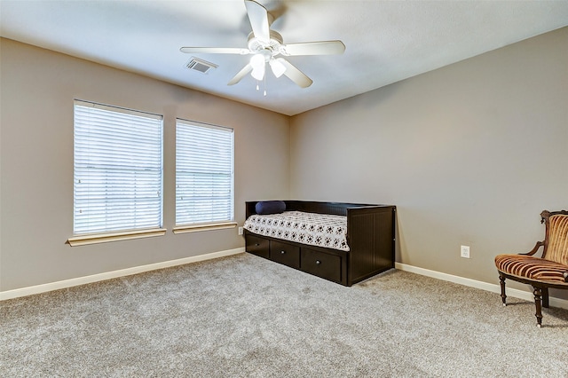 bedroom with carpet flooring, visible vents, baseboards, and a ceiling fan