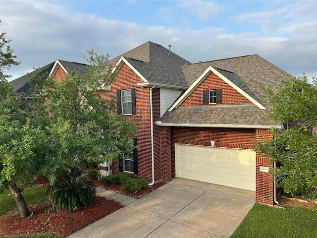11603 Shoal Landing St, Pearland, TX 77584 - traditional-style house featuring a shingled roof, concrete driveway, brick siding, and a garage