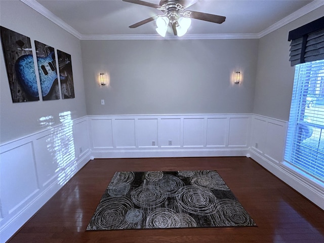 11603 Shoal Landing St, Pearland, TX 77584 - empty room with crown molding, dark wood-type flooring, a ceiling fan, wainscoting, and a decorative wall