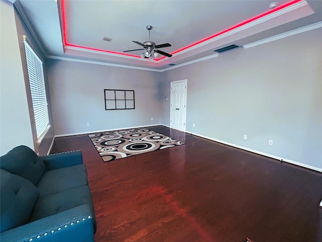 11603 Shoal Landing St, Pearland, TX 77584 - unfurnished living room with a raised ceiling, ceiling fan, ornamental molding, wood finished floors, and plenty of natural light