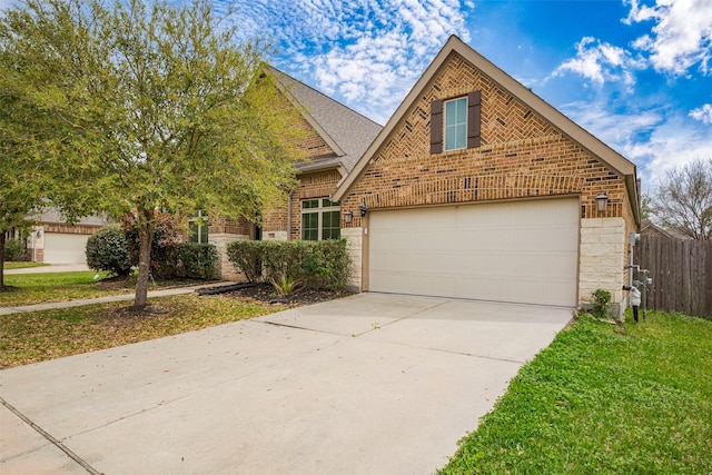 traditional-style home with concrete driveway, brick siding, fence, and a garage