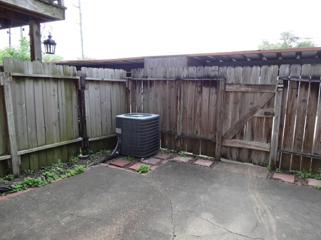 view of patio / terrace featuring central AC and fence