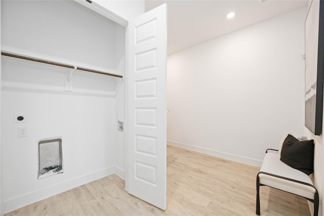 clothes washing area featuring baseboards, recessed lighting, laundry area, and light wood-style floors