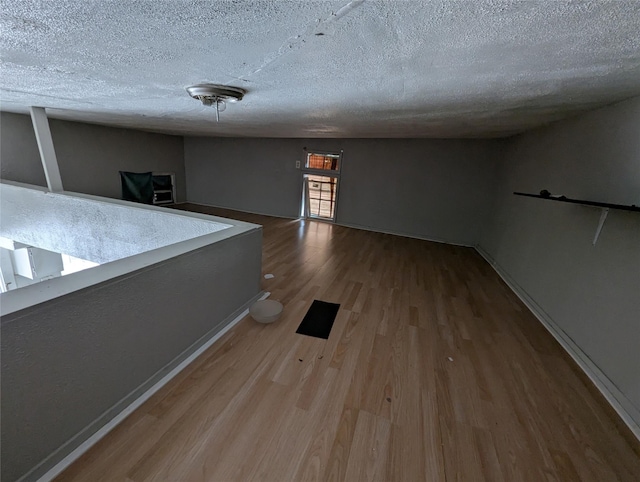 706 66th St Unit 2, Houston, TX 77011 - spare room with a textured ceiling, baseboards, and wood finished floors
