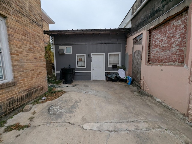 706 66th St Unit 2, Houston, TX 77011 - view of home's exterior featuring a patio, a wall mounted air conditioner, and metal roof