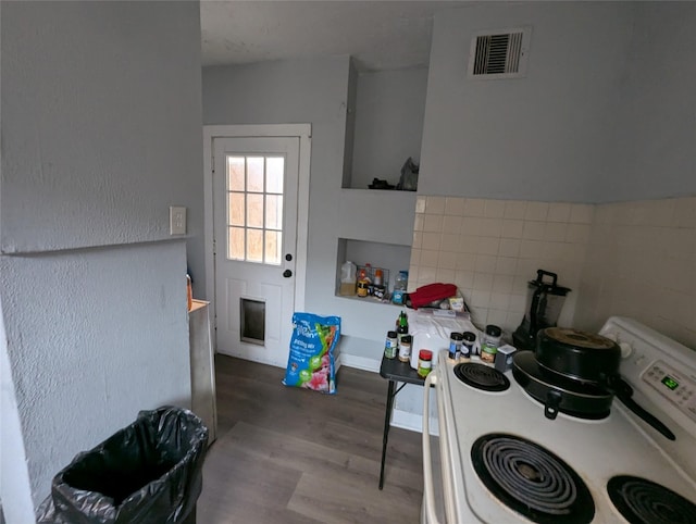 706 66th St Unit 2, Houston, TX 77011 - kitchen featuring electric stove, visible vents, wood finished floors, and tile walls