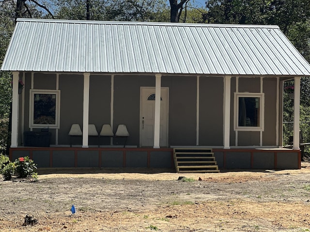 view of front of property featuring covered porch and metal roof
