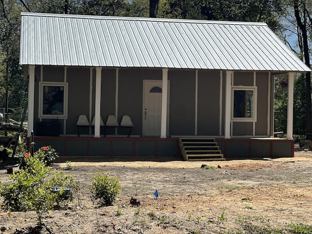 view of front of home featuring metal roof and covered porch