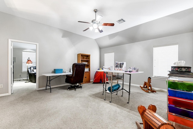 home office featuring carpet floors, visible vents, vaulted ceiling, and a ceiling fan