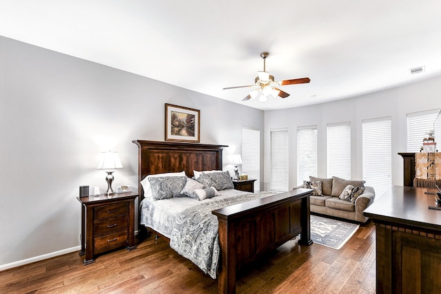 bedroom with baseboards, visible vents, a ceiling fan, and wood-type flooring