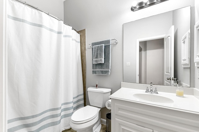 bathroom featuring toilet and vanity