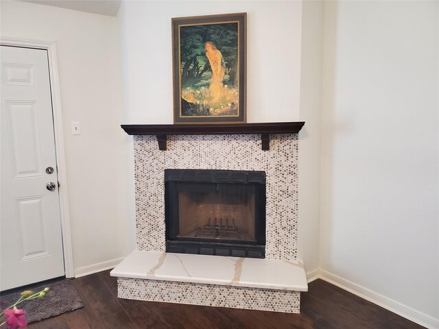 13002 Nantucket Dr, Sugar Land, TX 77478 - interior details with a tile fireplace, baseboards, and wood finished floors