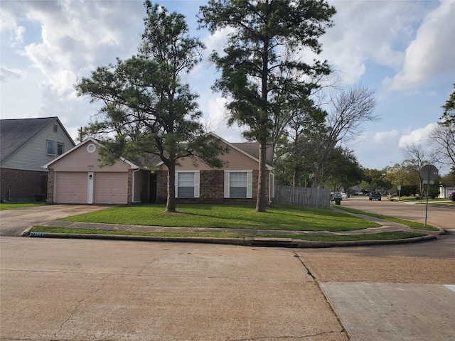 13002 Nantucket Dr, Sugar Land, TX 77478 - view of front facade with brick siding, driveway, a front yard, and a garage