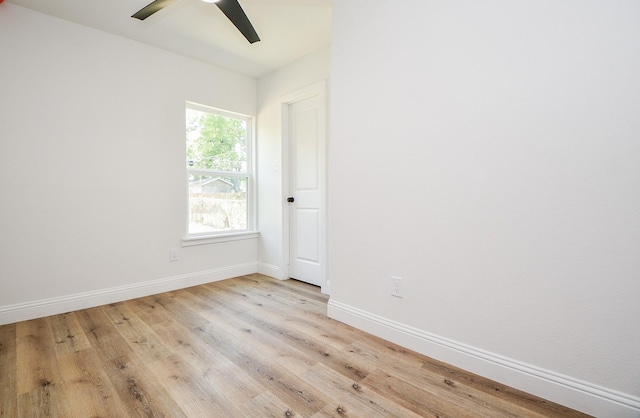 spare room with light wood-style flooring, baseboards, and ceiling fan
