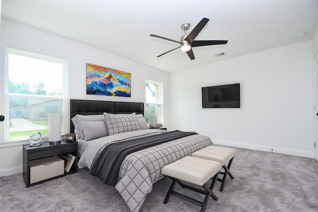 bedroom featuring carpet floors, visible vents, baseboards, and ceiling fan