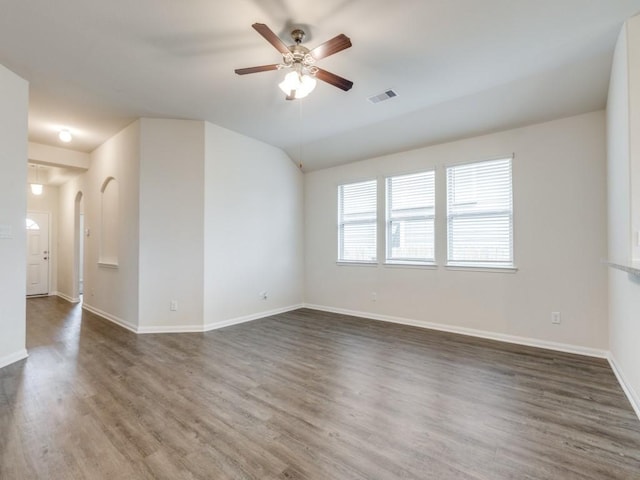 13088 Laura Lake Dr, Willis, TX 77318 - empty room with baseboards, a ceiling fan, visible vents, lofted ceiling, and wood finished floors