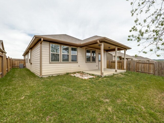 13088 Laura Lake Dr, Willis, TX 77318 - rear view of house with a patio area, a fenced backyard, and a lawn