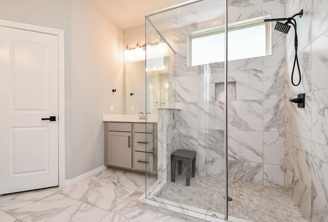 11115 Elderflower Dr, Missouri City, TX 77459 - bathroom featuring marble look tile flooring, a marble finish shower, vanity, and baseboards