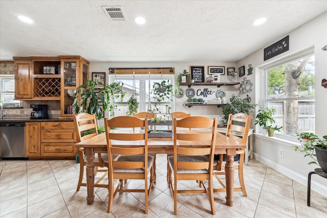 4010 Bluebonnet Trl, Deer Park, TX 77536 - dining room featuring plenty of natural light, a textured ceiling, recessed lighting, and light tile patterned floors