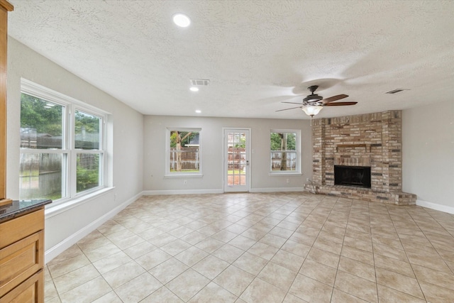 4010 Bluebonnet Trl, Deer Park, TX 77536 - unfurnished living room featuring a ceiling fan, light tile patterned flooring, a textured ceiling, recessed lighting, and a brick fireplace
