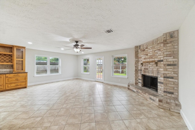 4010 Bluebonnet Trl, Deer Park, TX 77536 - unfurnished living room with a ceiling fan, light tile patterned floors, a brick fireplace, a textured ceiling, and recessed lighting
