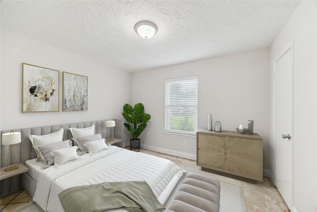 4010 Bluebonnet Trl, Deer Park, TX 77536 - bedroom with a textured ceiling and baseboards