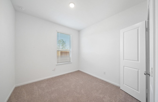 10710 Sora Dr, Willis, TX 77378 - carpeted empty room with baseboards and a smoke detector
