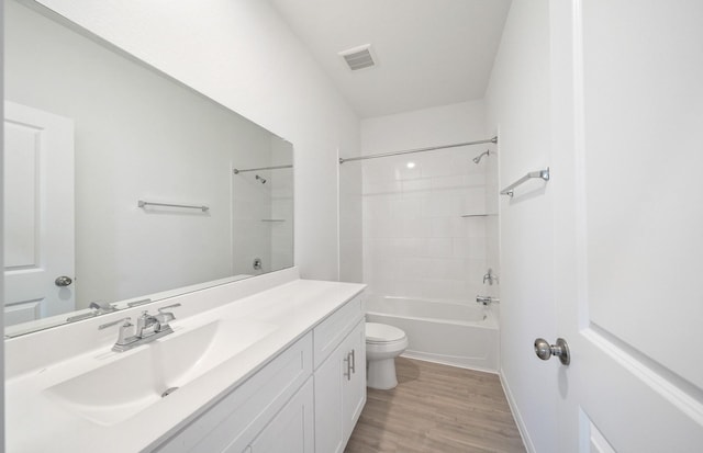 10710 Sora Dr, Willis, TX 77378 - full bathroom featuring toilet, wood finished floors, vanity, and washtub / shower combination