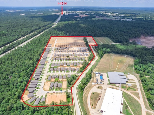 10710 Sora Dr, Willis, TX 77378 - aerial view of property and surrounding area featuring a forest and property parcel outlined