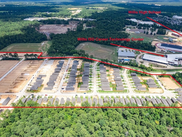 10710 Sora Dr, Willis, TX 77378 - aerial view of property and surrounding area with property boundaries highlighted and a heavily wooded area