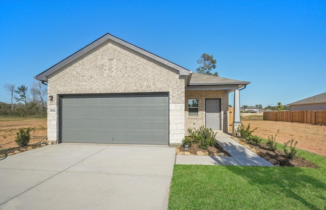 10710 Sora Dr, Willis, TX 77378 - ranch-style home with brick siding, concrete driveway, and an attached garage