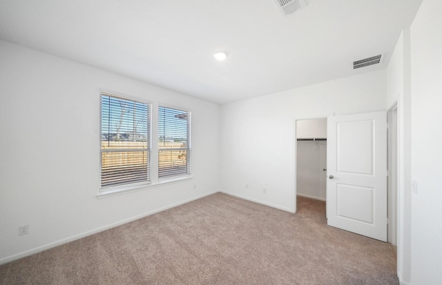 10710 Sora Dr, Willis, TX 77378 - unfurnished bedroom with carpet flooring, baseboards, a walk in closet, and a closet