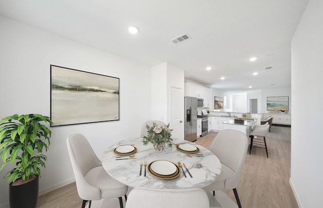 10710 Sora Dr, Willis, TX 77378 - dining room featuring light wood-style flooring, recessed lighting, and baseboards