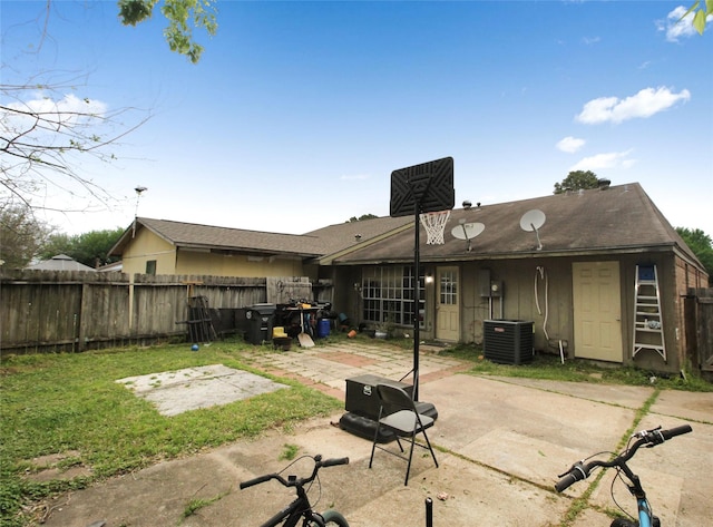 rear view of house with cooling unit, fence, and a patio